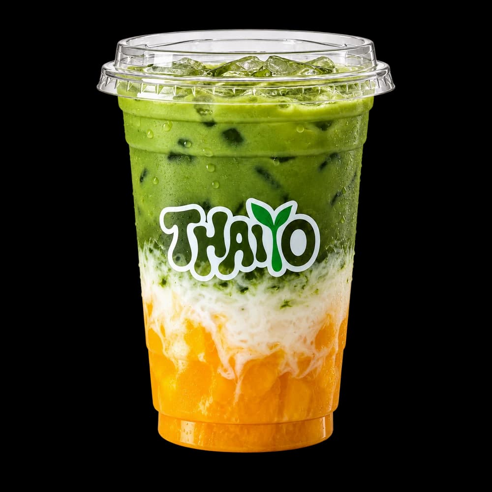 Custom branded clear cold cup with a fitted lid and a matcha drink